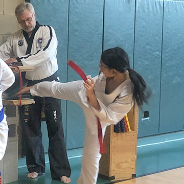 female youth break board kick