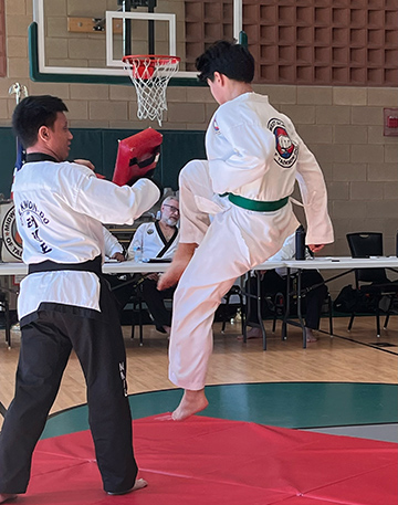 Elgin younger student jump kick tuck